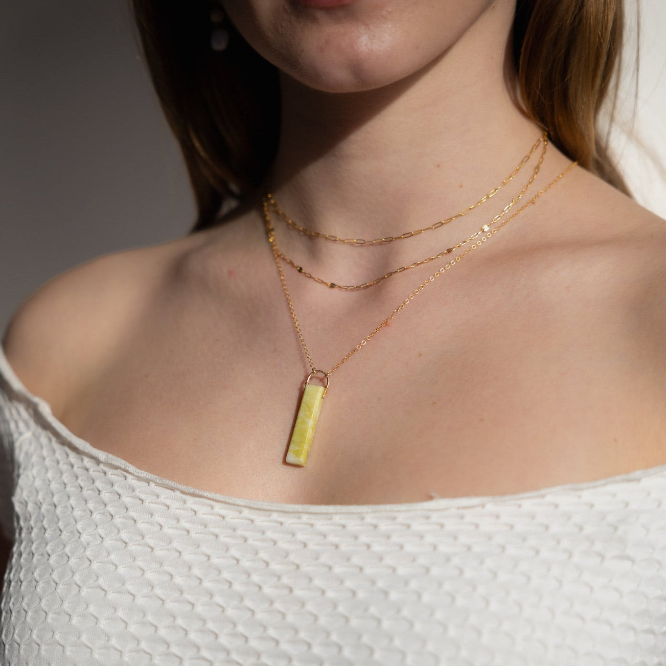 model wearing 14k gold fill chain necklaces paired with 14k gold fill delicate chain necklace with serpentine pendant