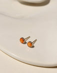 Sienna Studs featuring 4mm fiery orange spiny oyster cabochons in sterling silver bezel settings.