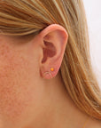 Model wearing Sienna Studs featuring 4mm fiery orange spiny oyster cabochons in 14k gold filled bezel settings.