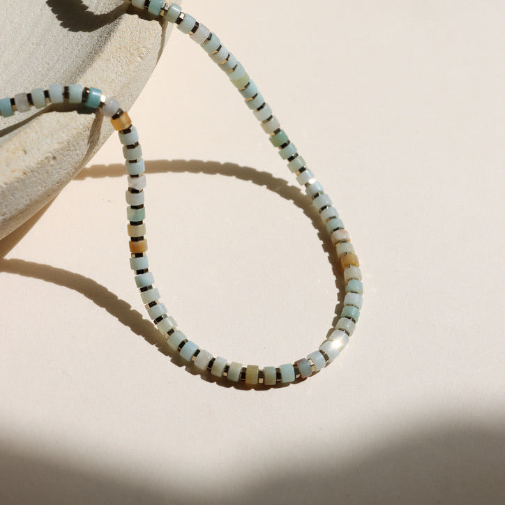 amazonite beaded necklace on a light dish