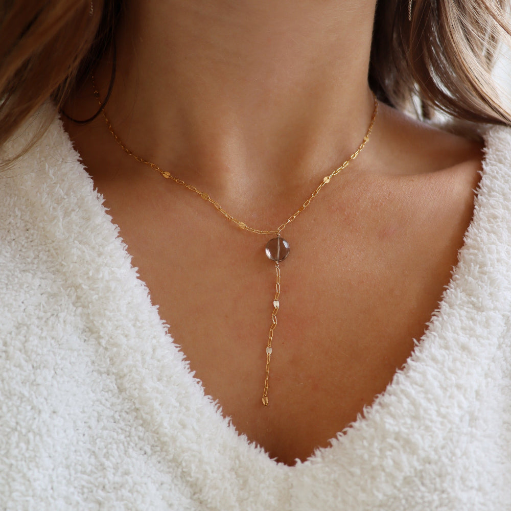 Delicate gold lariat necklace featuring a smooth smoky quartz pendant on the Sunspell chain, handcrafted for a warm, minimal look.