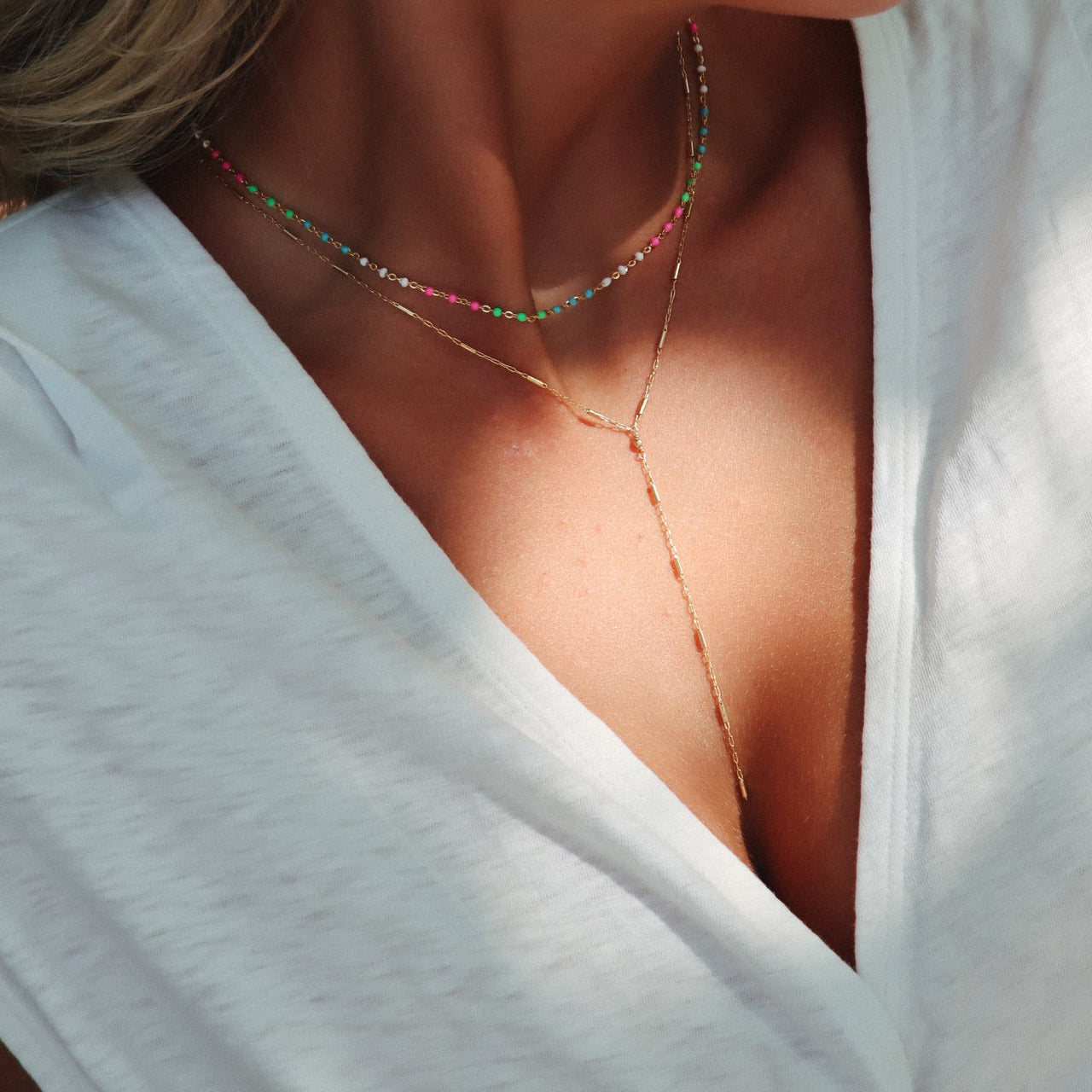 model wearing 14k gold fill chain lariat necklace with chain and enamel choker necklace