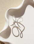 Isla Ring laid on a white plate in the sunlight.