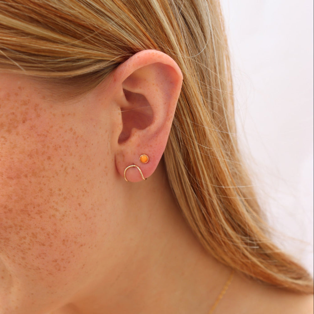 14k gold filled sunrise studs on a model.
