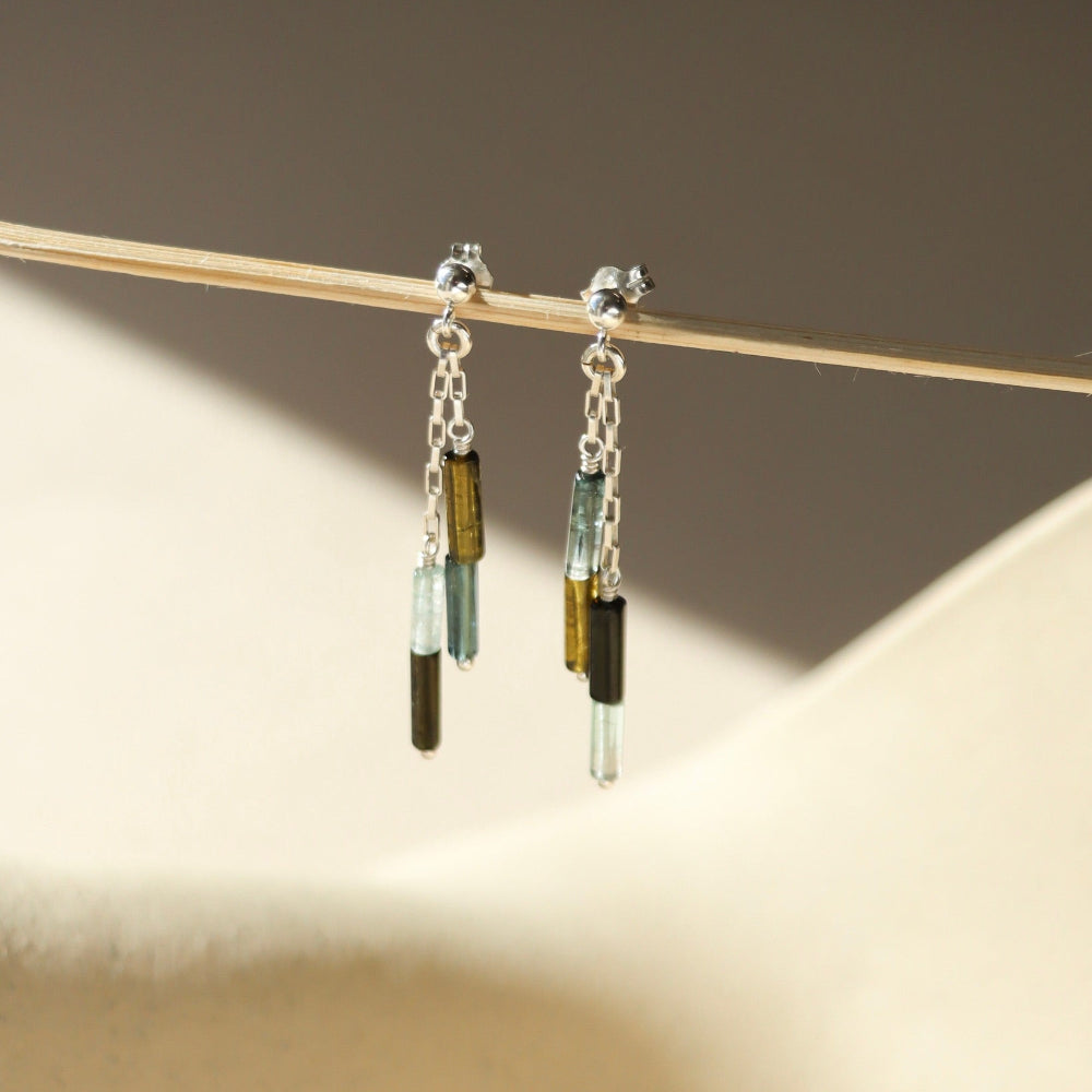 sterling silver stud earrings with chain and tourmaline beads in the sunlight