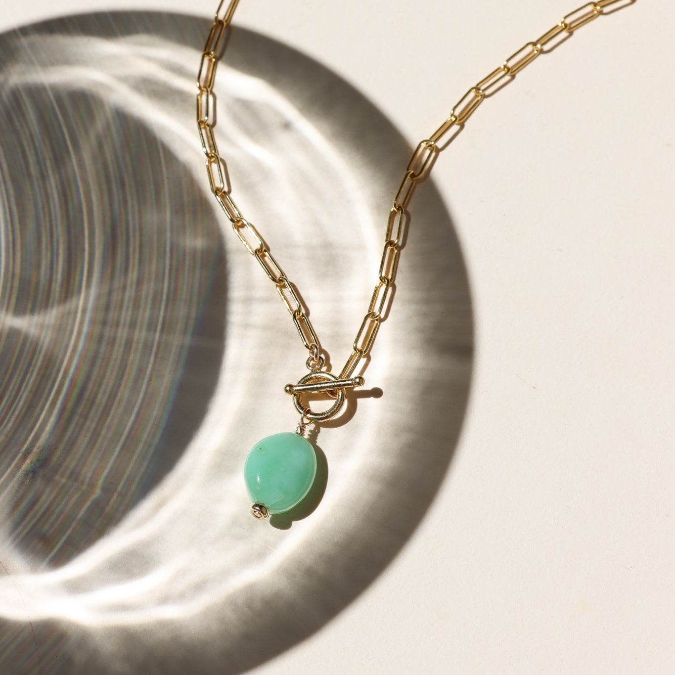 14k gold fill paperclip chain necklace with toggle clasp and chrysoprase stone in the sunlight