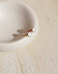 14k gold fill Opal Studs laid on a white plate in the sunlight.  - Token Jewelry