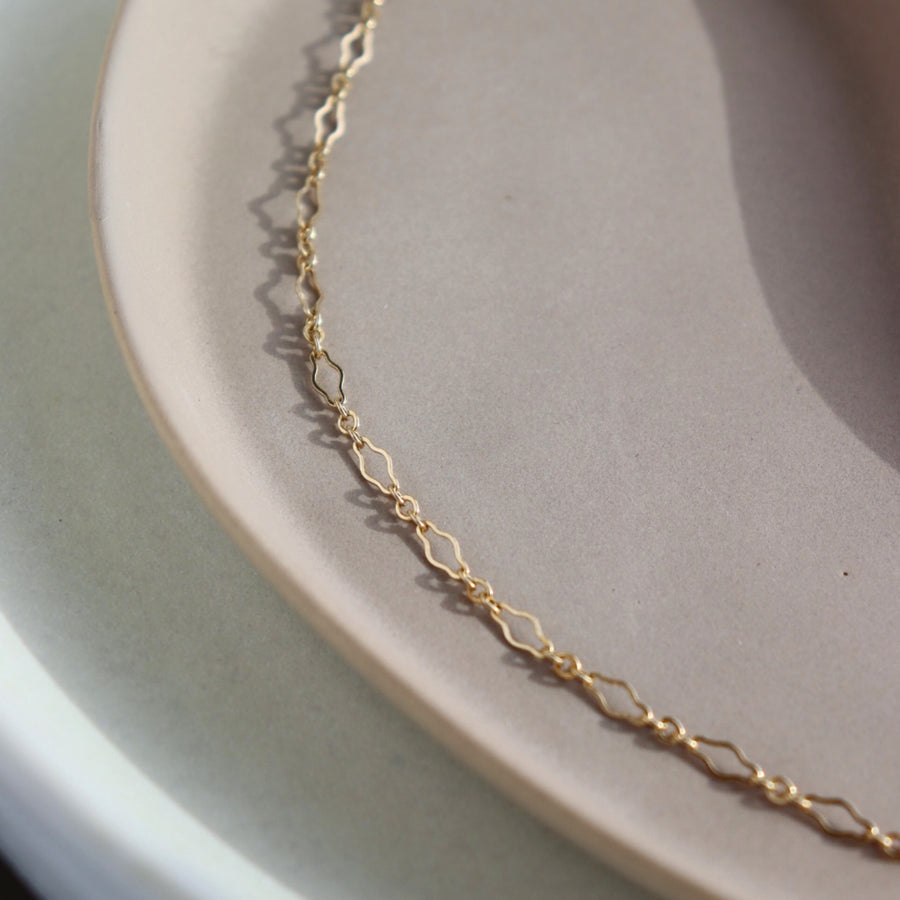 Feminine curvy chain linked bracelet in 14k gold fill. Spring hook clasp closure and half inch extender to make the bracelet adjustable. Handmade by Token Jewelry in Eau Claire, WI